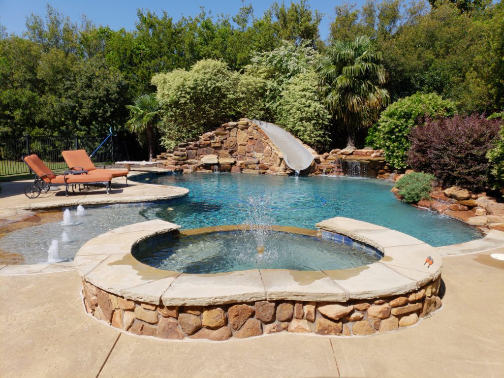 Amazing water feature next to a pool