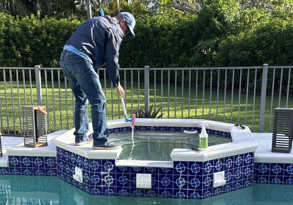 Chris proferming Tile cleaning after a pool build